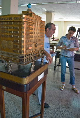Museum of the Grand lodge of Cuba. Museum curator and author of this article at the model of the grand lodge building in Havana.