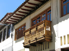 Red tiled roofs and jolly carved balconies
